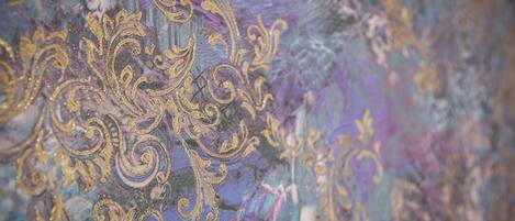A close-up of a fabric with intricate golden embroidery.