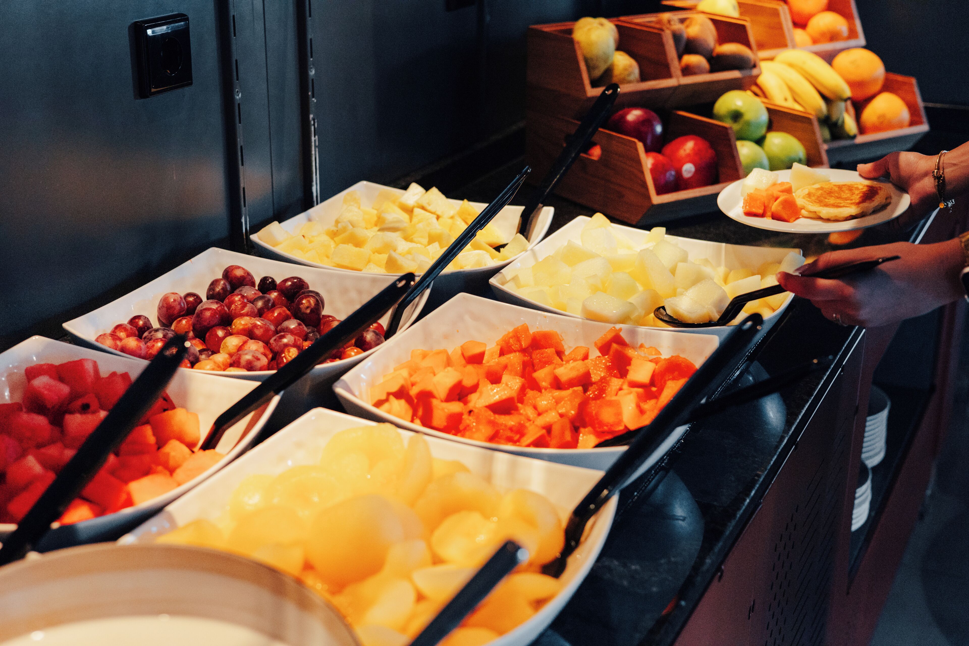A buffet with various fruits and vegetables.