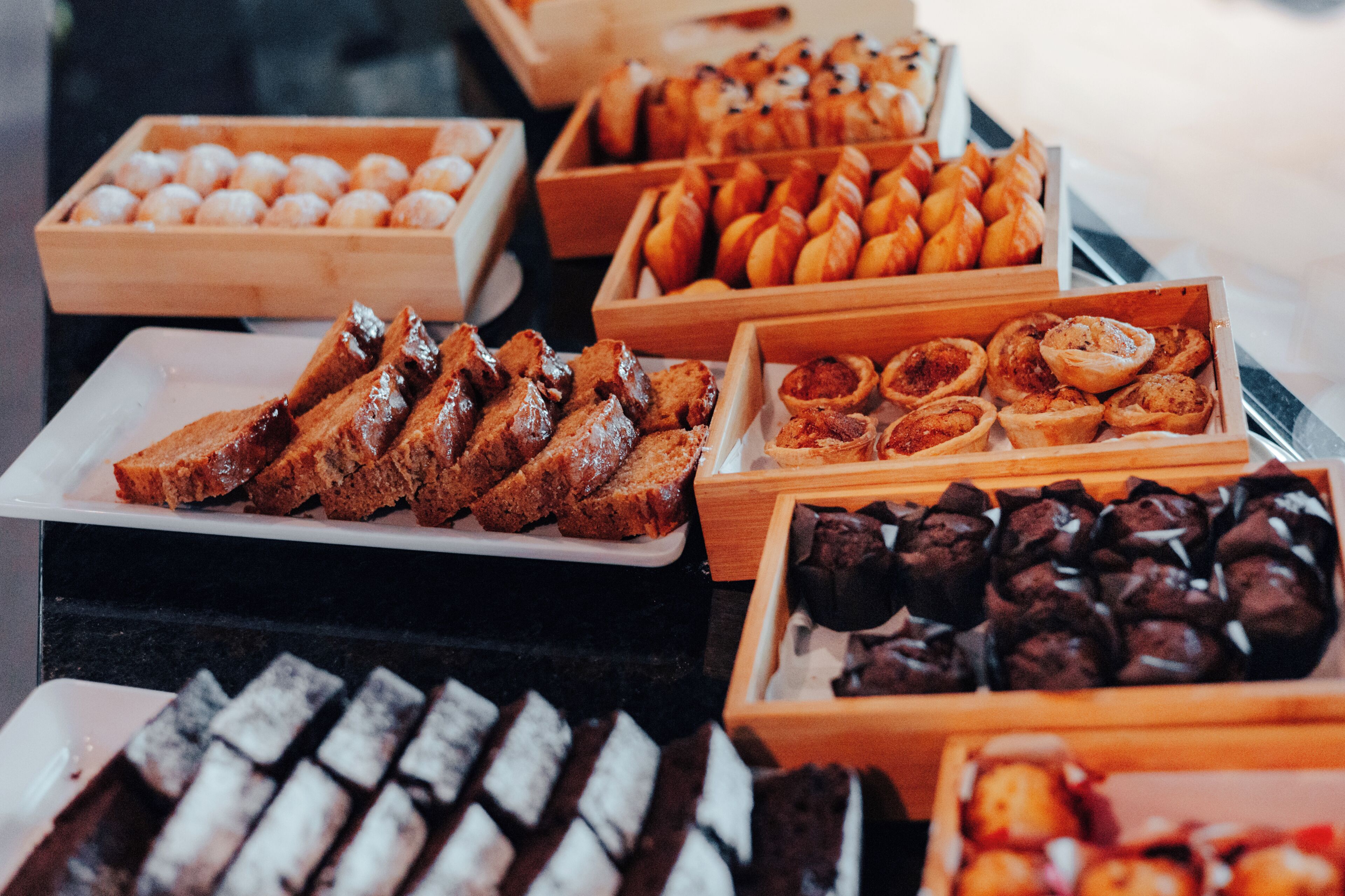 A variety of baked goods displayed in wooden boxes.
