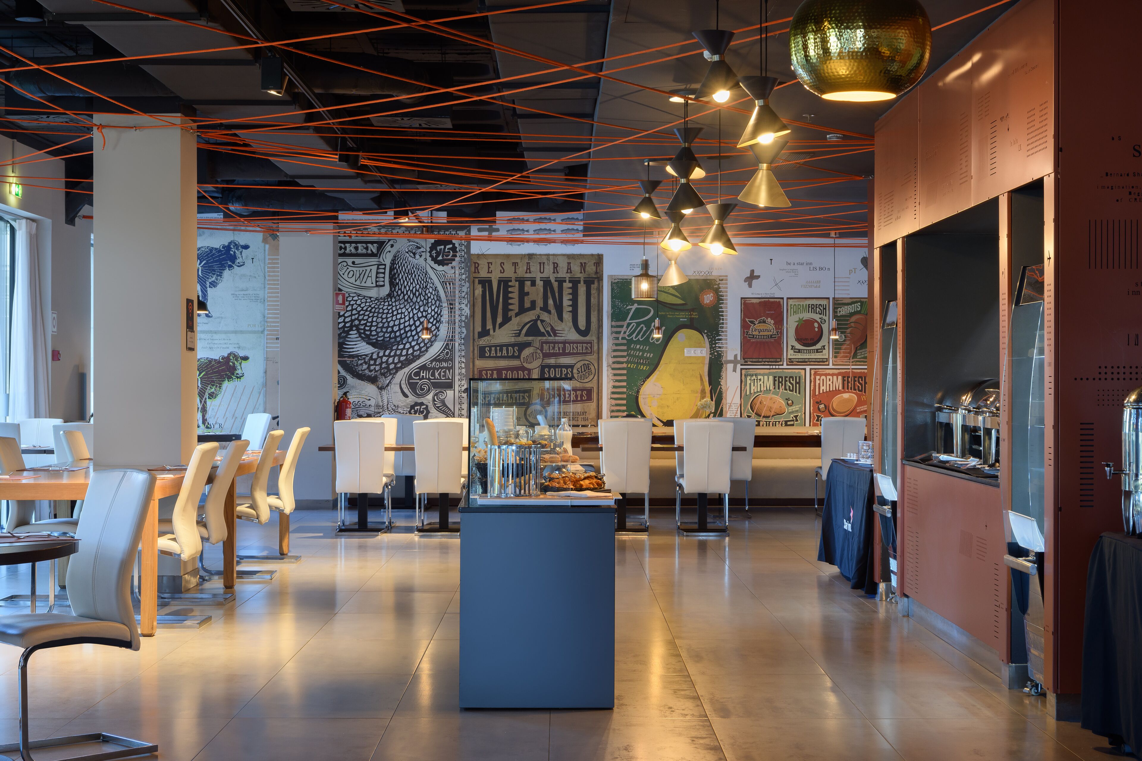 Un intérieur de restaurant moderne avec un bar central, plusieurs tables et chaises.