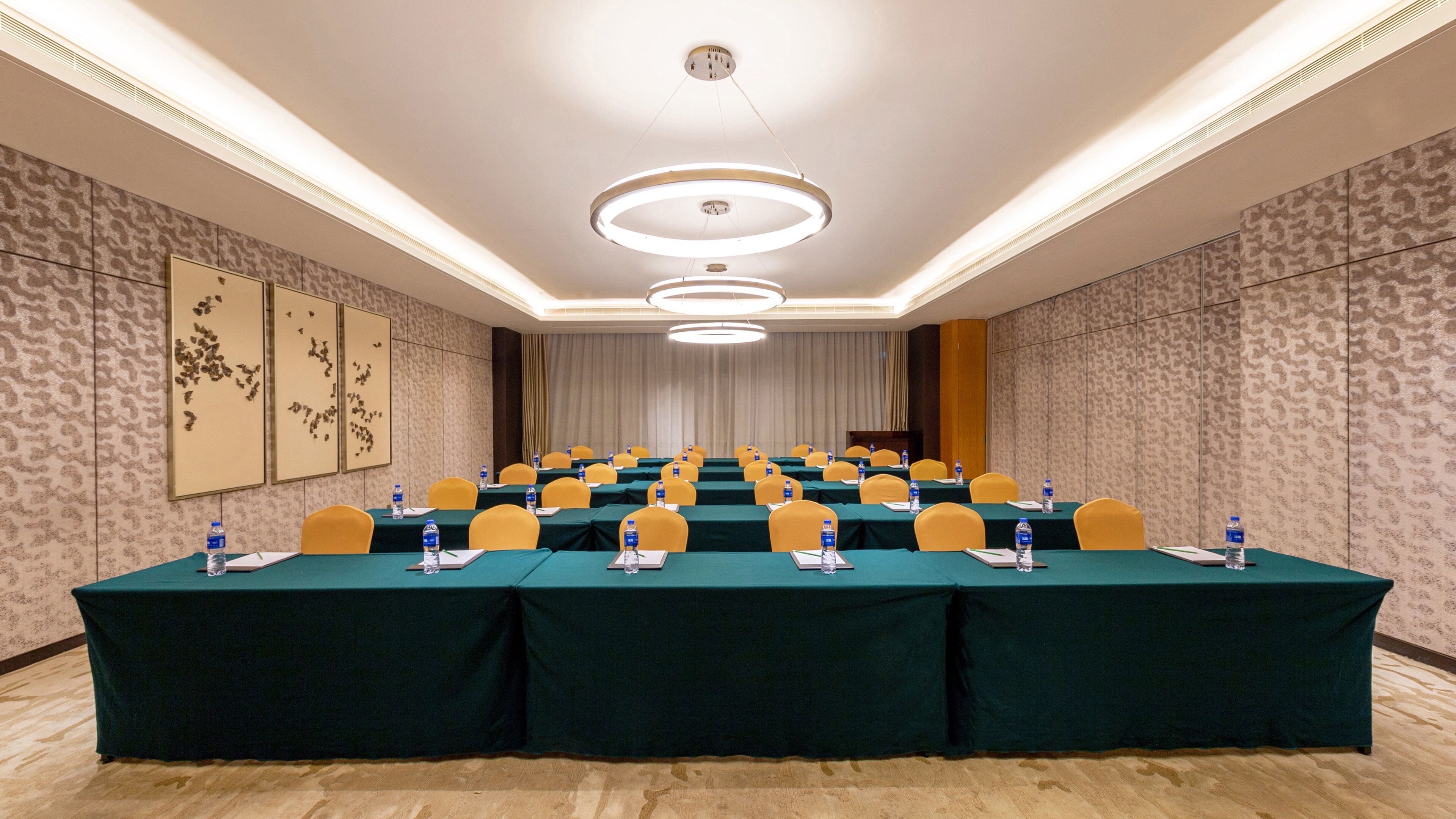 A conference room with a long table, chairs, water bottles, and nameplates.