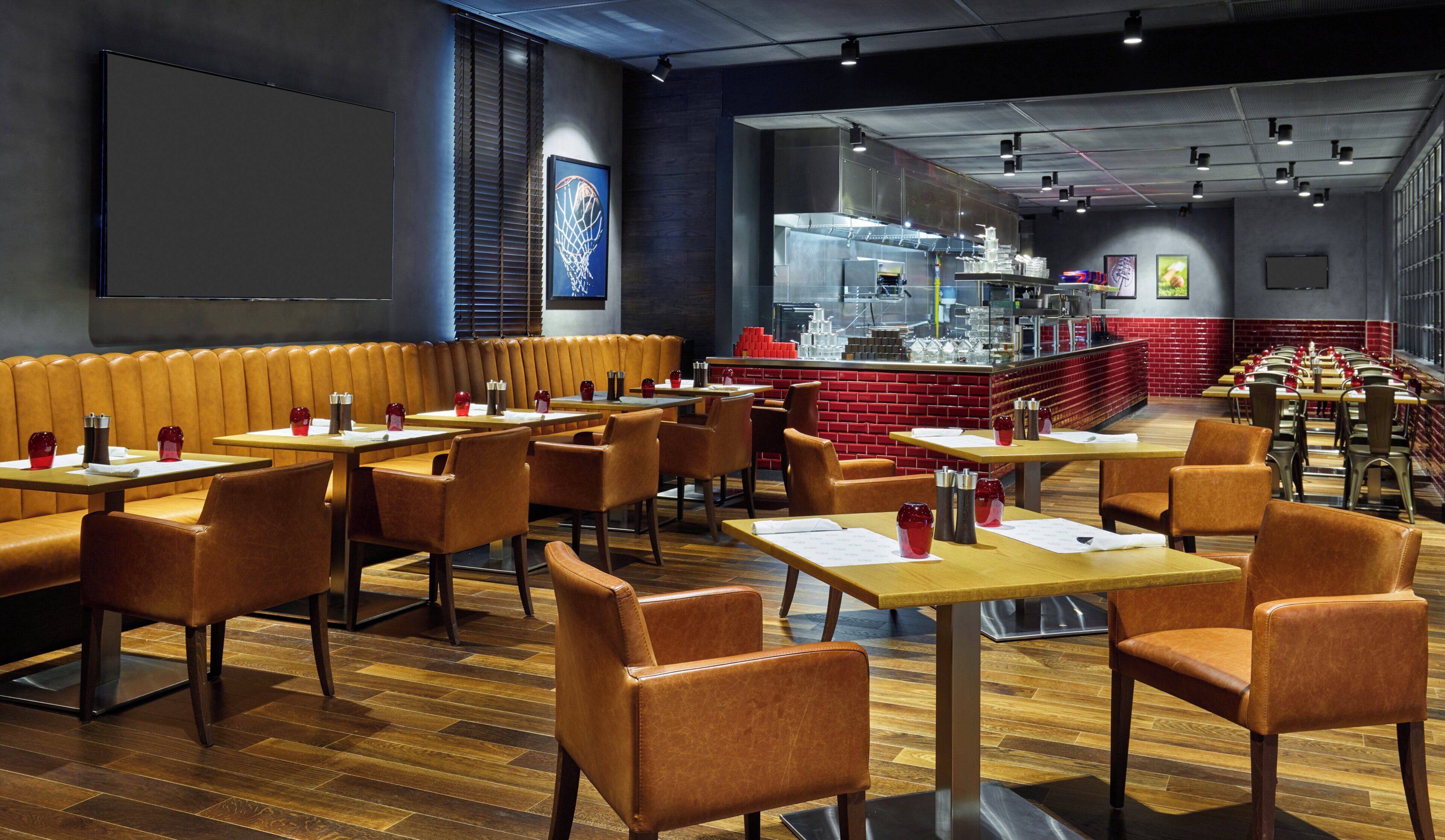 A restaurant interior with booths, tables, and a bar area.
