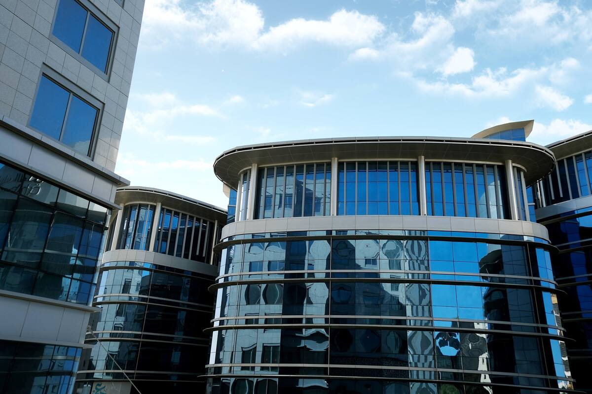A modern building with curved glass windows and a reflective facade.