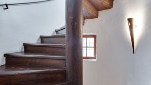 Una escalera de madera con un ventanal en la parte superior.