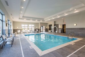 An indoor swimming pool with clear water, surrounded by lounge chairs and a tiled floor. - Hampton Inn & Suites West Lafayette (West Lafayette)