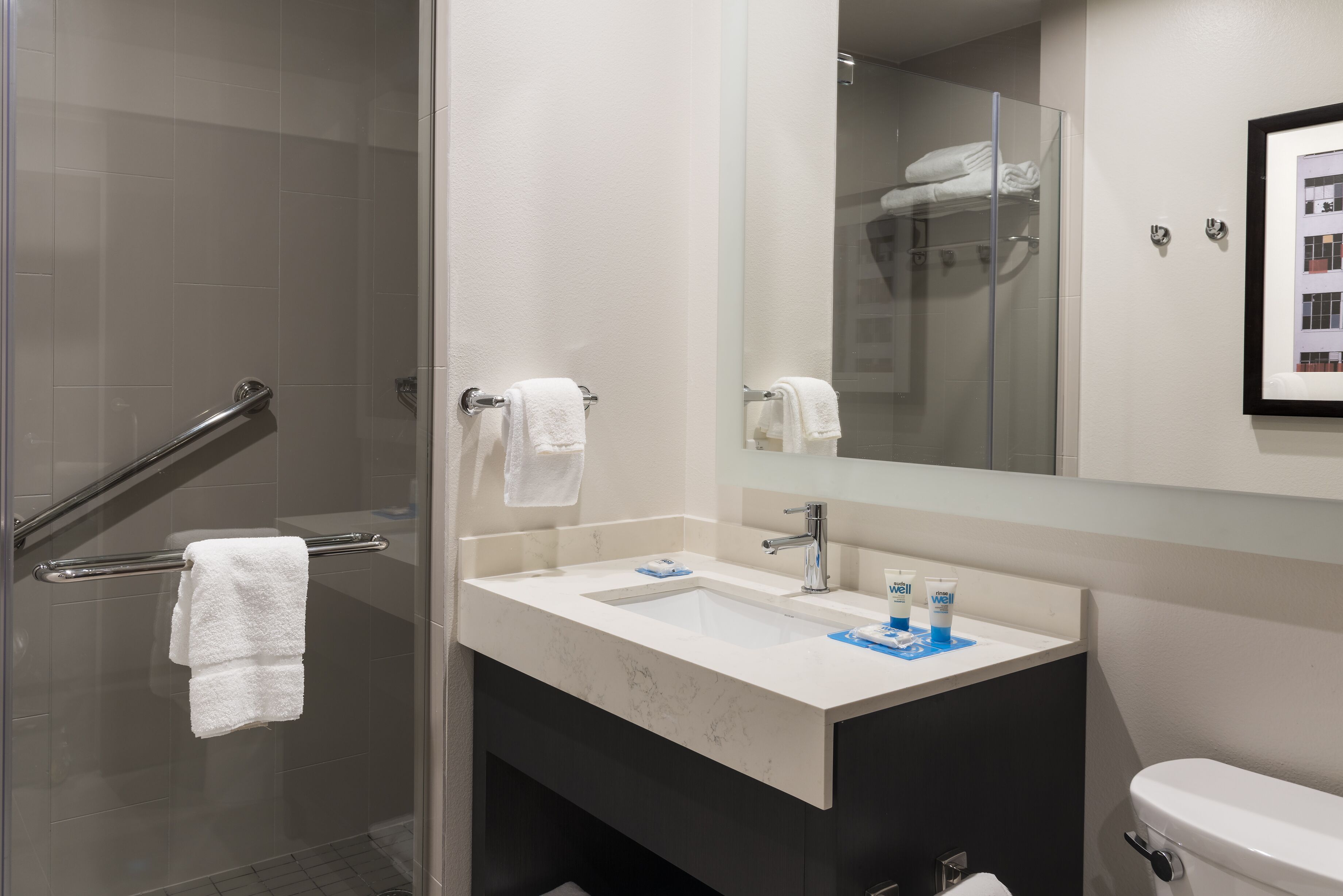 combined shower/bathtub, designer toiletries, hair dryer, towels