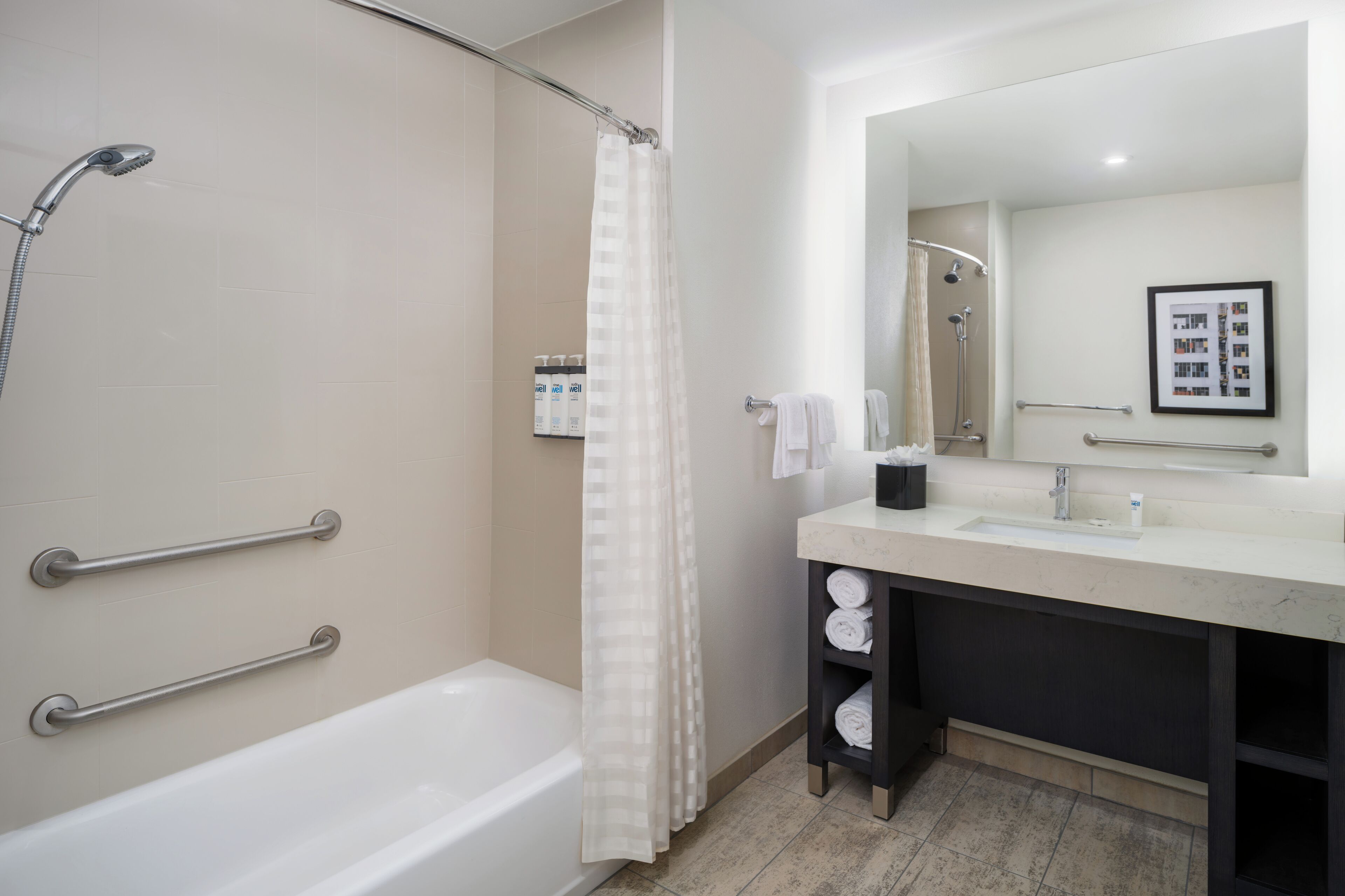 combined shower/bathtub, designer toiletries, hair dryer, towels