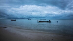 A beach with calm waters and boats. - The Pier Koh Phangan (Ko Pha-ngan)