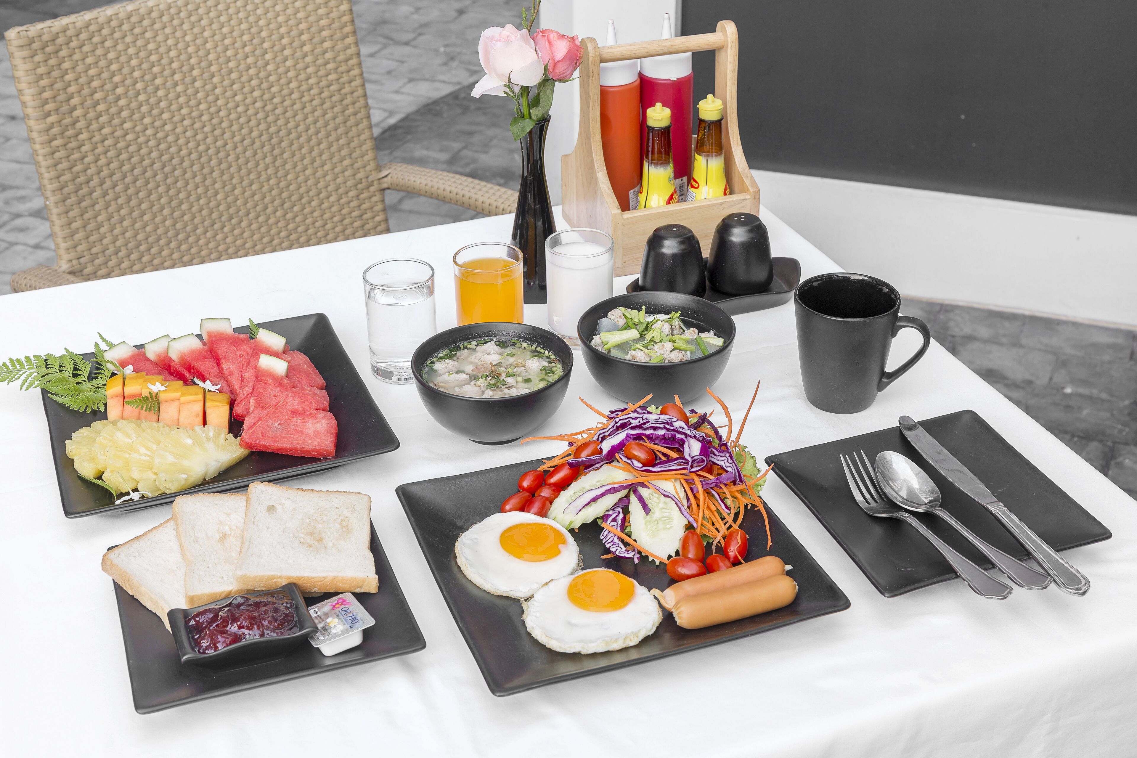 A breakfast table with various dishes including toast, eggs, and a salad.