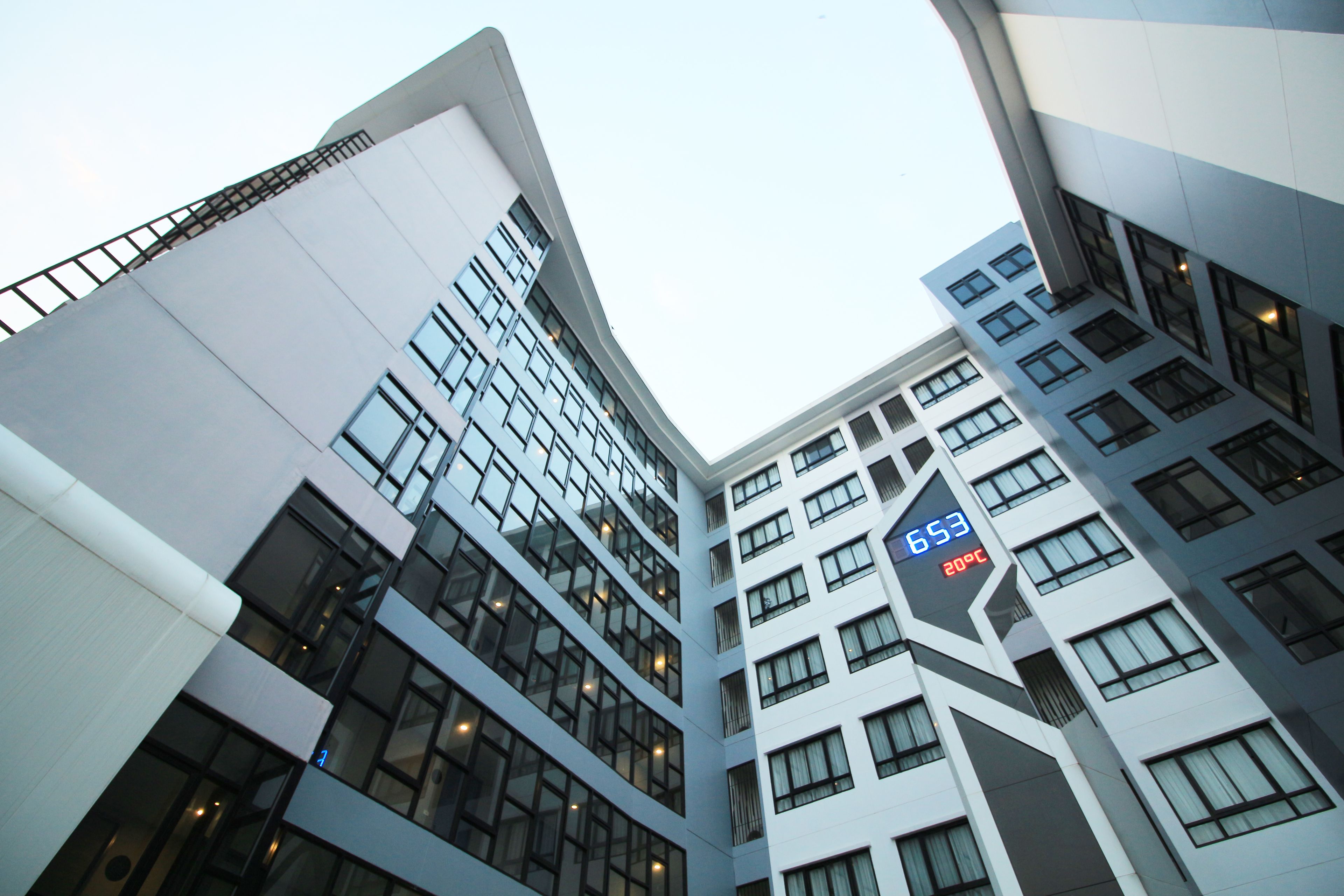 A modern high-rise building with multiple floors and large windows.