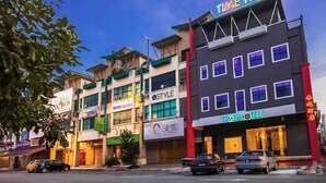 A hotel with multiple floors, a prominent 'TIME HOTEL' sign, and various storefronts including 'eSTYLE' and 'WISMA KARAHI'. - Time Hotel Sunway (Petaling Jaya)