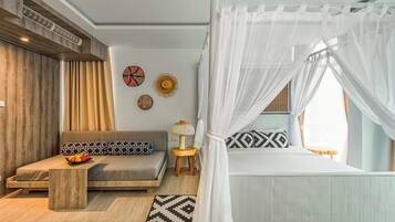 A modern bedroom with a bed, a sofa, a nightstand, and decorative wall art.