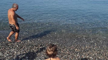 Guests can enjoy swimming and sunbathing in this beach setting.