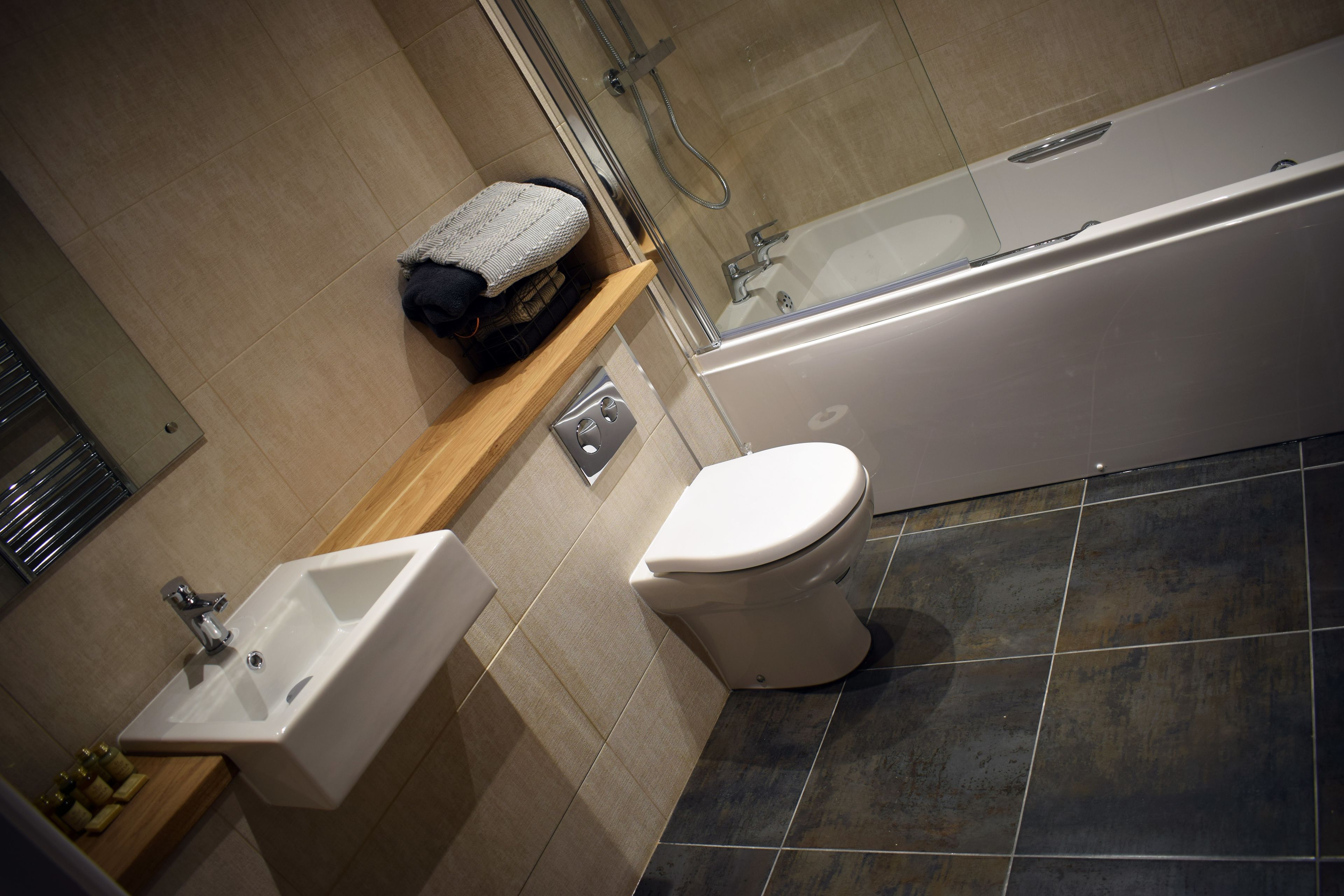 A bathroom with a sink, toilet, and bathtub.