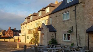 A row of stone buildings with a sign reading "Houses." - The Horse & Jockey Wessington (Alfreton)