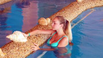 A person in a swimming pool with a shell.