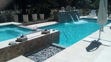 2 outdoor pools, open 11:00 AM to 8:00 PM, pool umbrellas, pool loungers