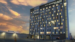 A modern hotel building with a flat facade and multiple windows.