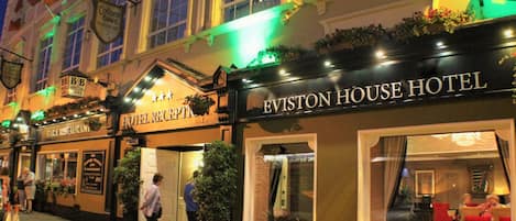 The exterior of the Eviston House Hotel with signage for the adjacent Colleen Bawn Restaurant.