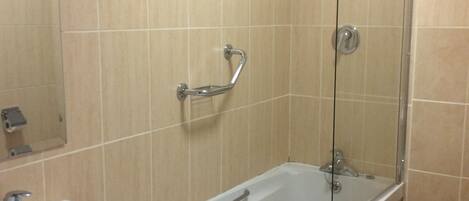 A bathroom with a bathtub, a sink, and a shower.