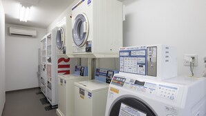 A laundry facility with multiple washing machines and dryers, control panels, and a fire extinguisher. - Comfort Hotel Toyohashi (Toyohashi)