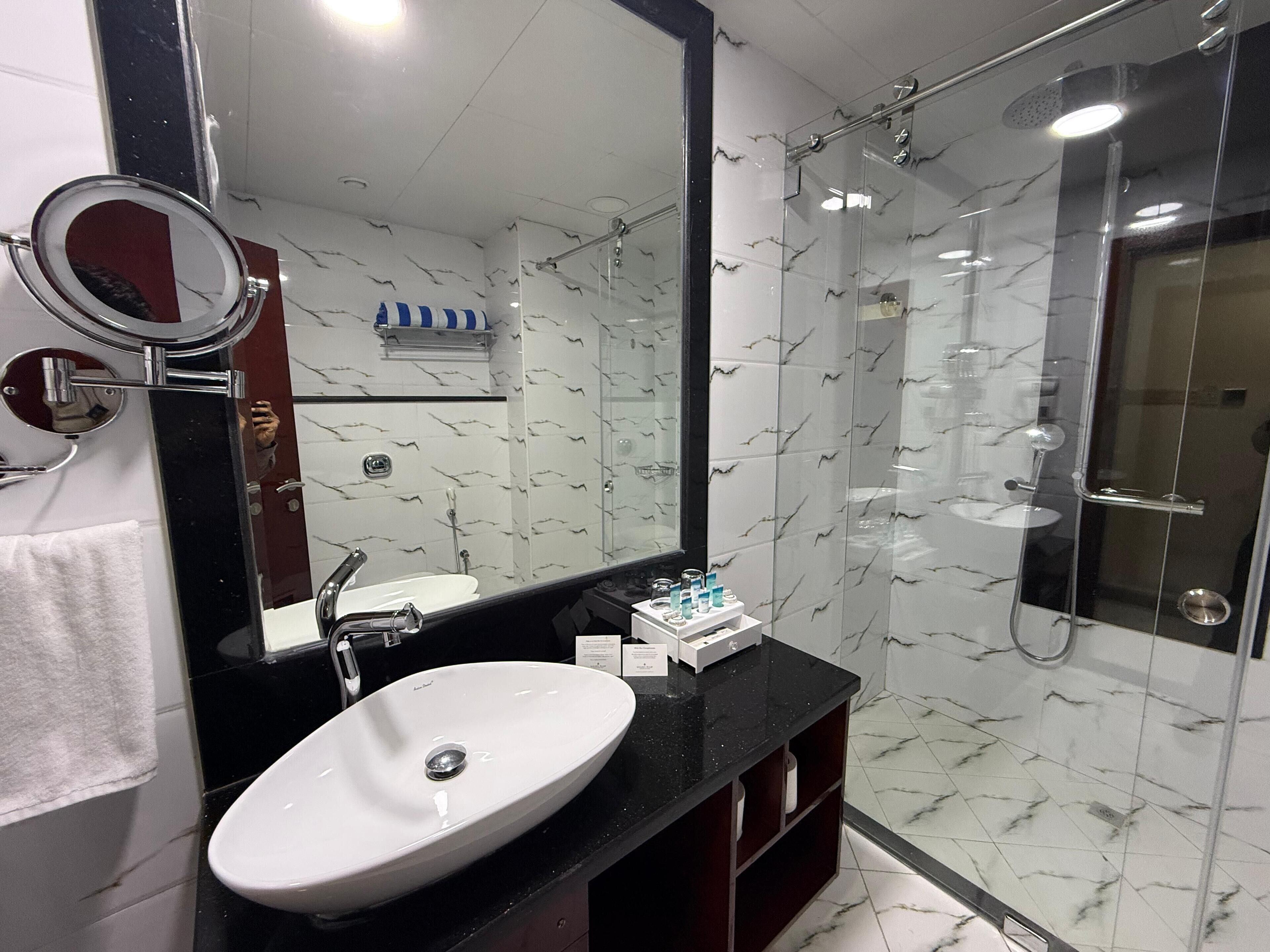 deluxe double room | bathroom | shower, rainfall showerhead, eco-friendly toiletries, hair dryer