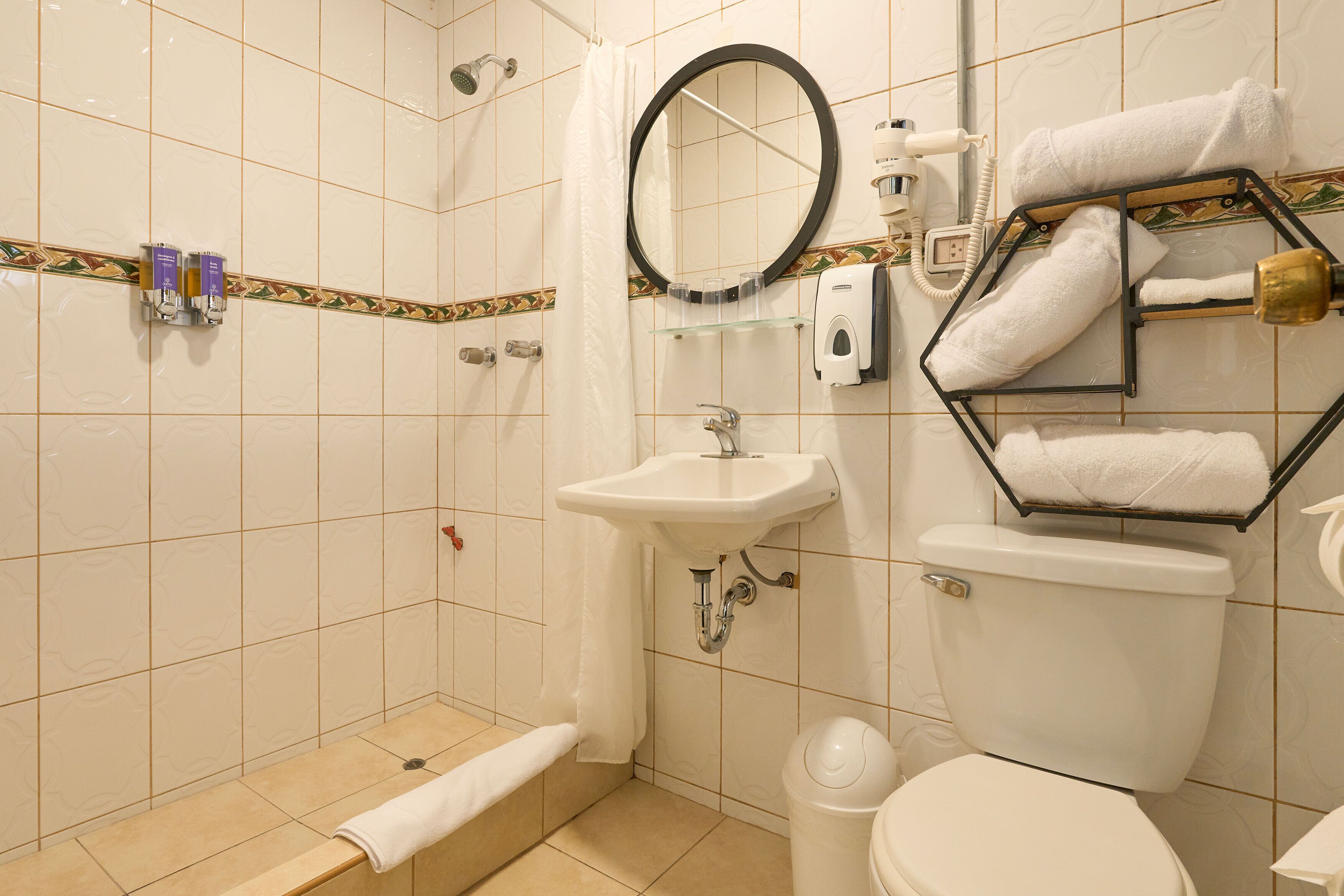 superior triple room | bathroom | shower, hair dryer, towels, soap