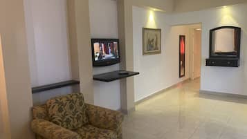 Estúdio básico, 1 quarto | Sala de estar | TV 20 polegadas com canais via satélite