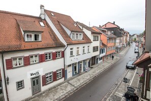 A narrow street lined with traditional European buildings, featuring a mix of residential and commercial properties. - Stadthaus Gut Hügle (Ravensburg)