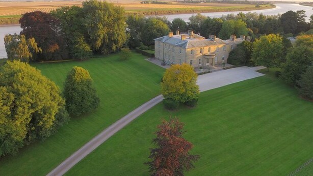 A large estate with a well-maintained lawn, a driveway, and a river in the background. - Saltmarshe Hall (Goole)