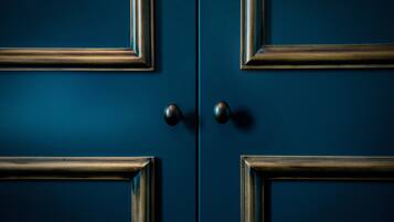 A set of four dark blue doors with a simple, classic design.