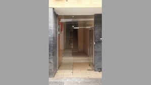 A glass door entrance to a building with a tiled floor and a metal handrail. - Ledras Town Center (Nicosia)