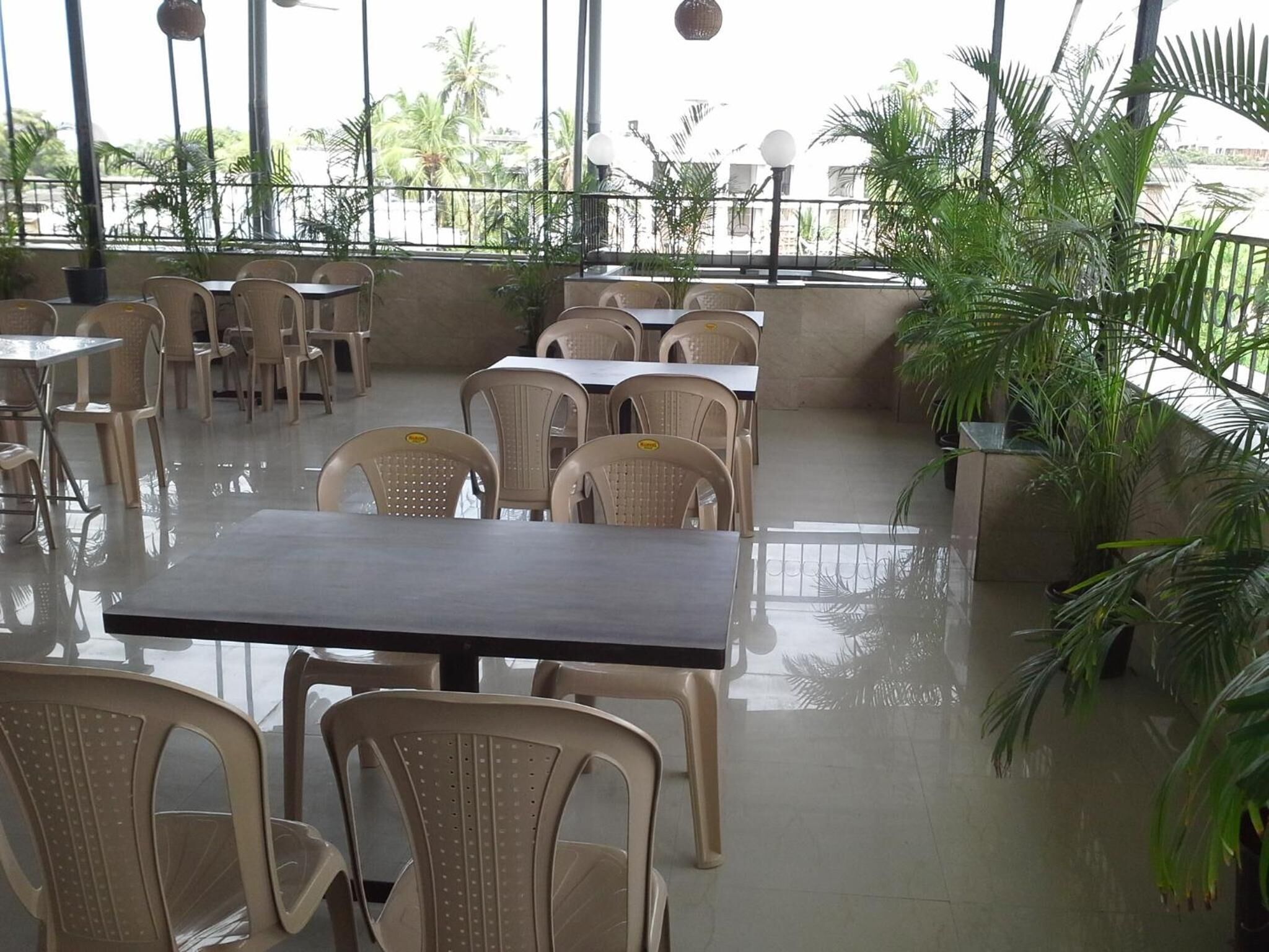 A spacious indoor area with tables and chairs arranged for dining.