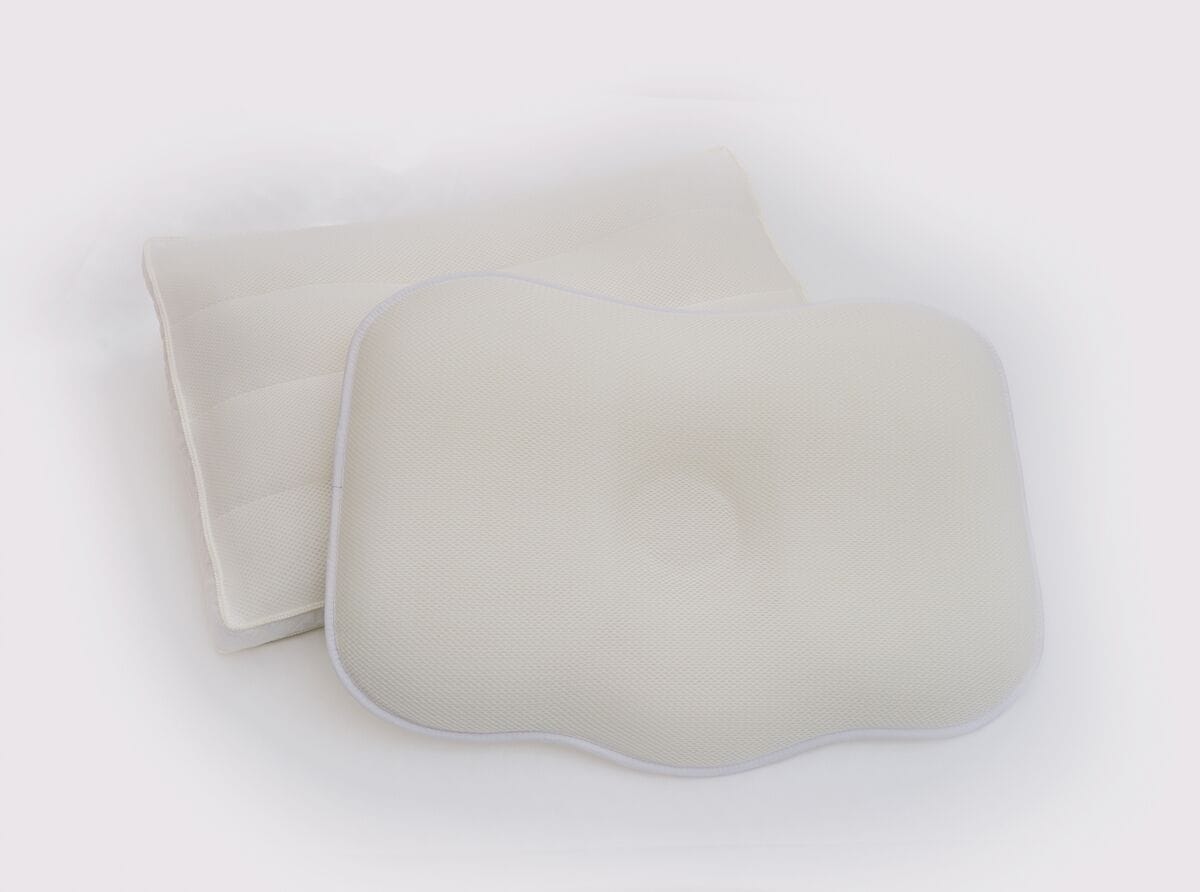 Two square-shaped, white, padded cushions with a textured surface and a rounded edge.