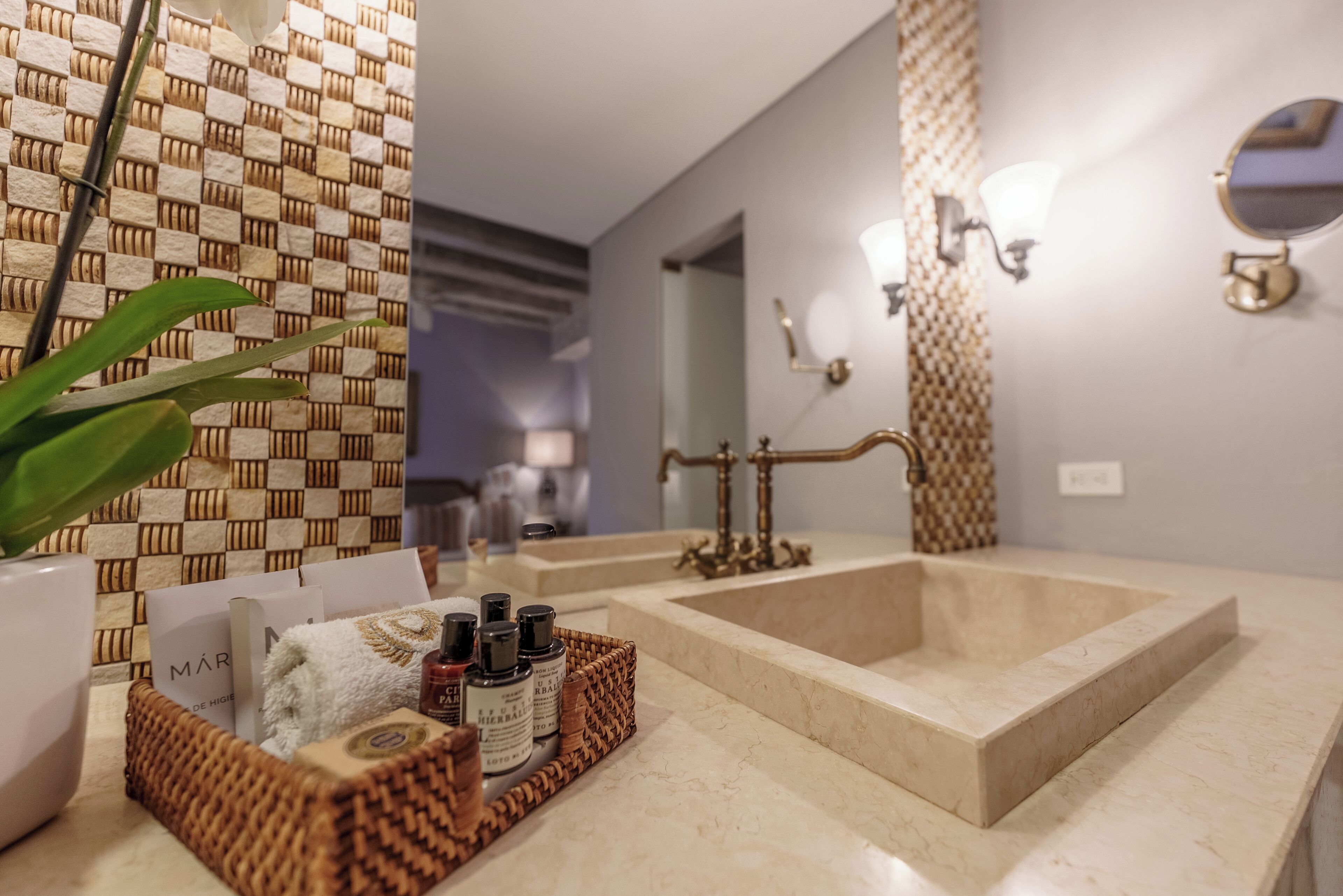 A bathroom with a large mirror, two sinks, and a decorative wall pattern.