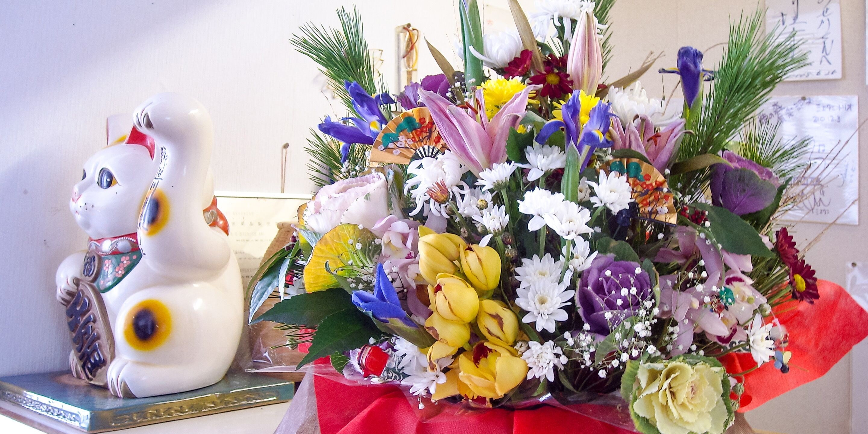 A ceramic rabbit figurine and a bouquet of flowers on a table.