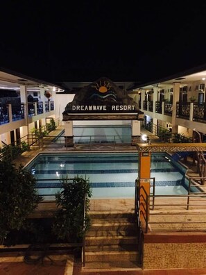 A resort with a pool, a sign reading "Dreamwave Resort," and a staircase leading to the pool area. - Dreamwave Resort Pansol (Calamba)