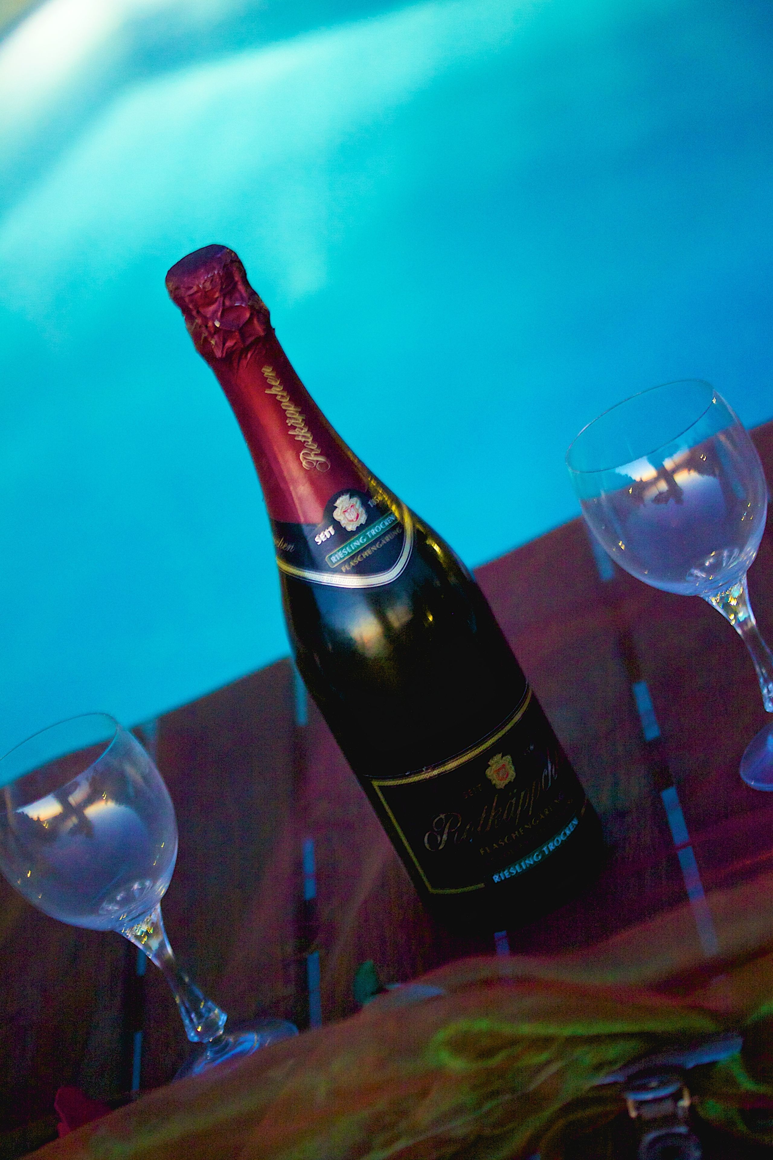 A bottle of champagne and two glasses on a table.