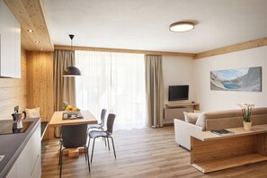 Superior Condo | Living area | 20-inch flat-screen TV with satellite channels, TV, heated floors - Residence Settsass (Corvara in Badia)