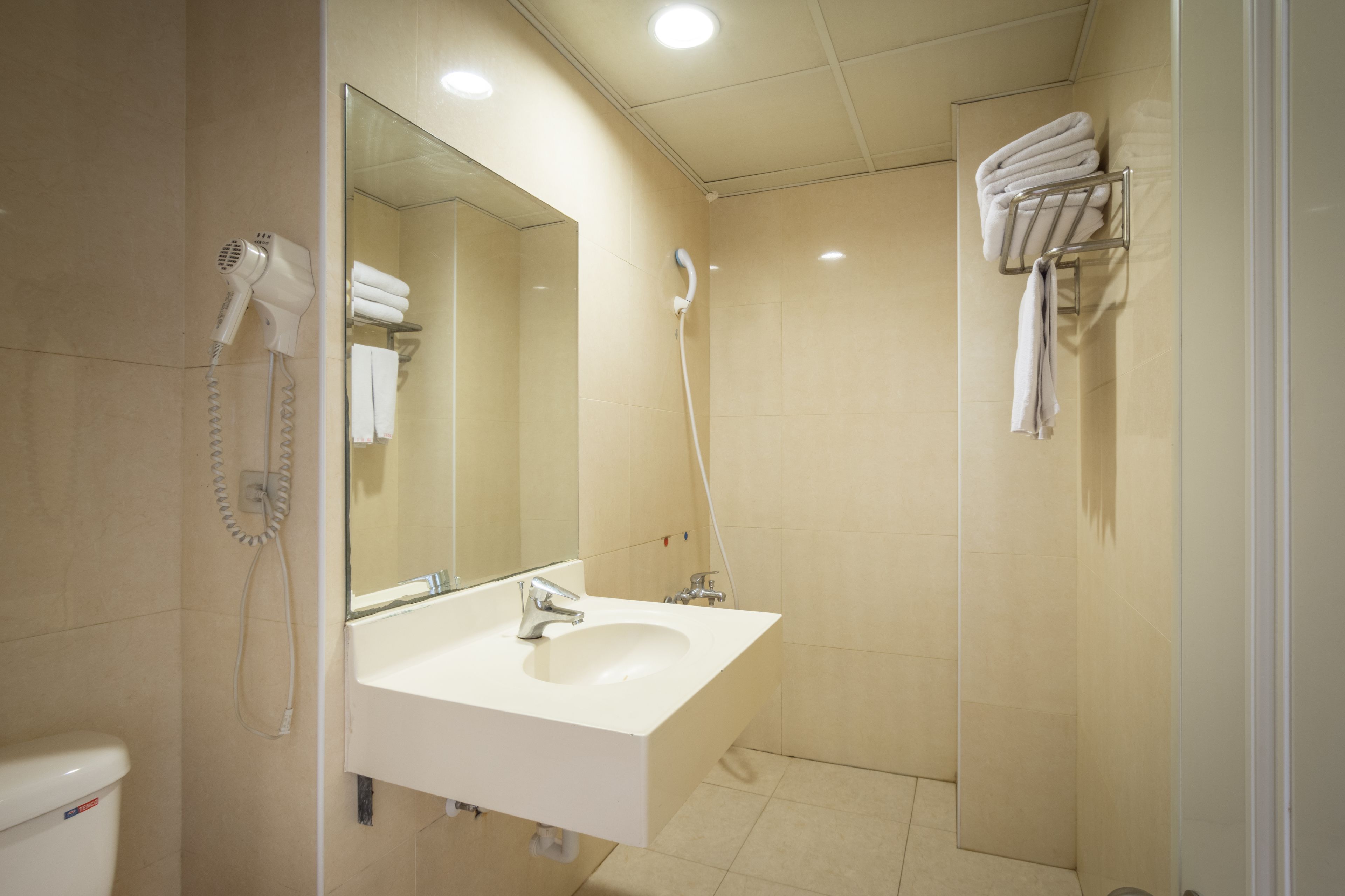 shower, hair dryer, slippers, towels