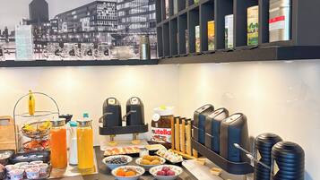 A breakfast buffet with various food items, condiments, and a coffee station.