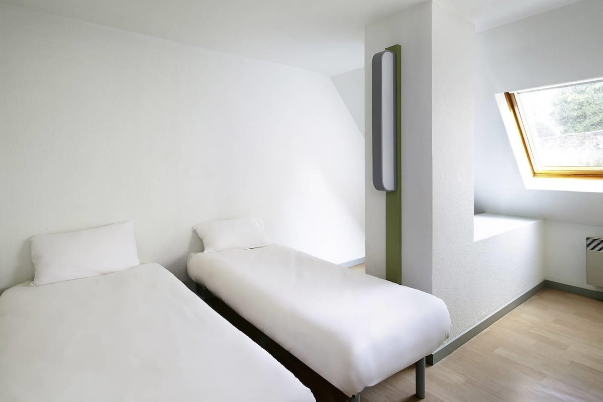 Hypo-allergenic bedding, down duvets, desk, laptop workspace