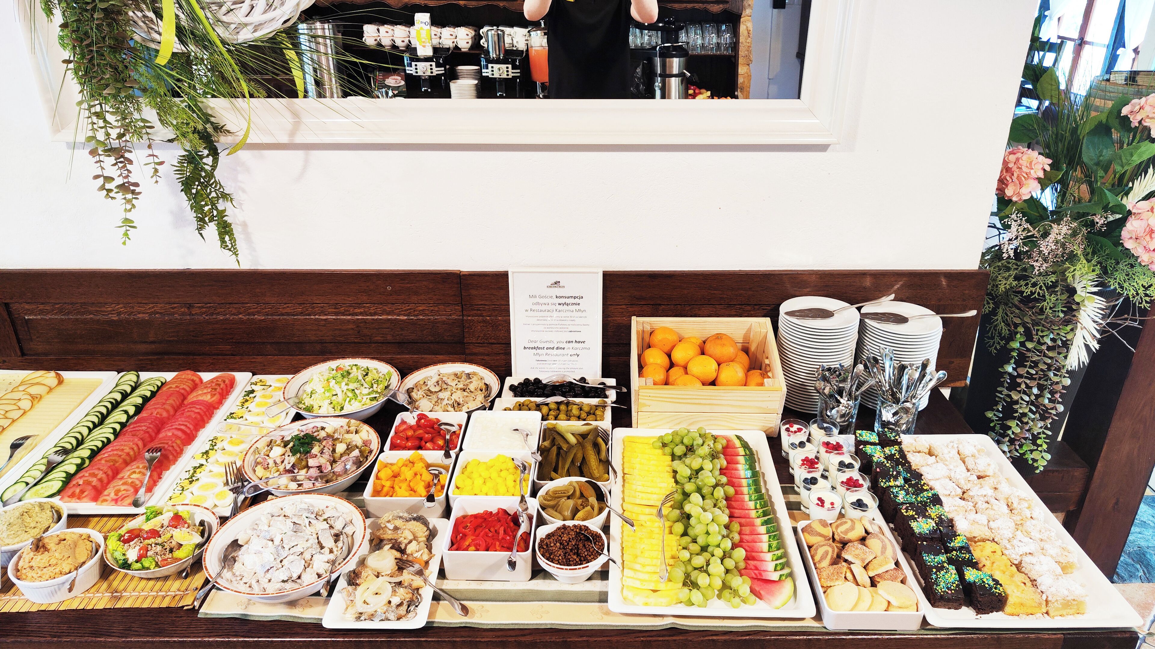 A buffet table with various food items and a coffee station.