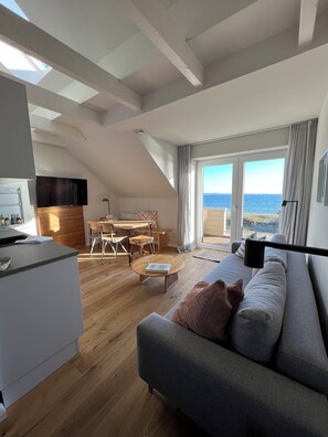 Deluxe Apartment, 2 Bedrooms, Sauna, Sea View (Dünenhaus) | Living area | Flat-screen TV - Ostsee-Strandhaus-Holnis (Gluecksburg)