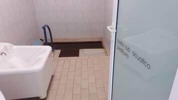 Bathroom features a bathtub and shower area with a window.