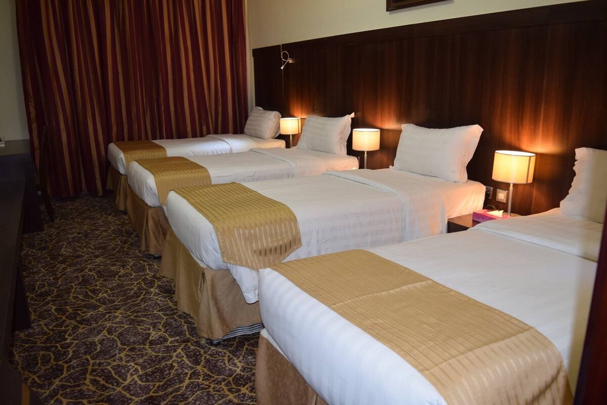 Quadruple Room | Minibar, in-room safe, blackout curtains, iron/ironing board