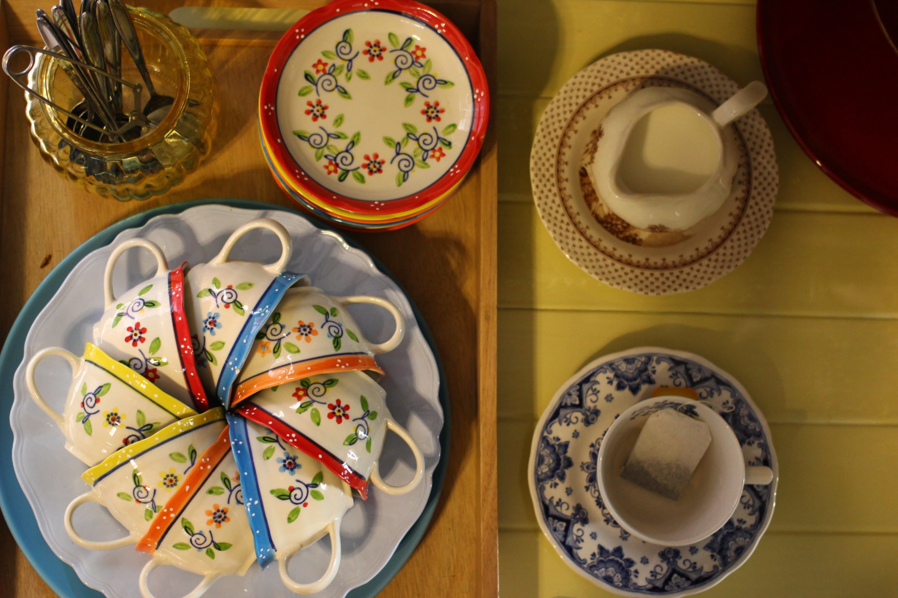 A table with various ceramic dishes and teacups.