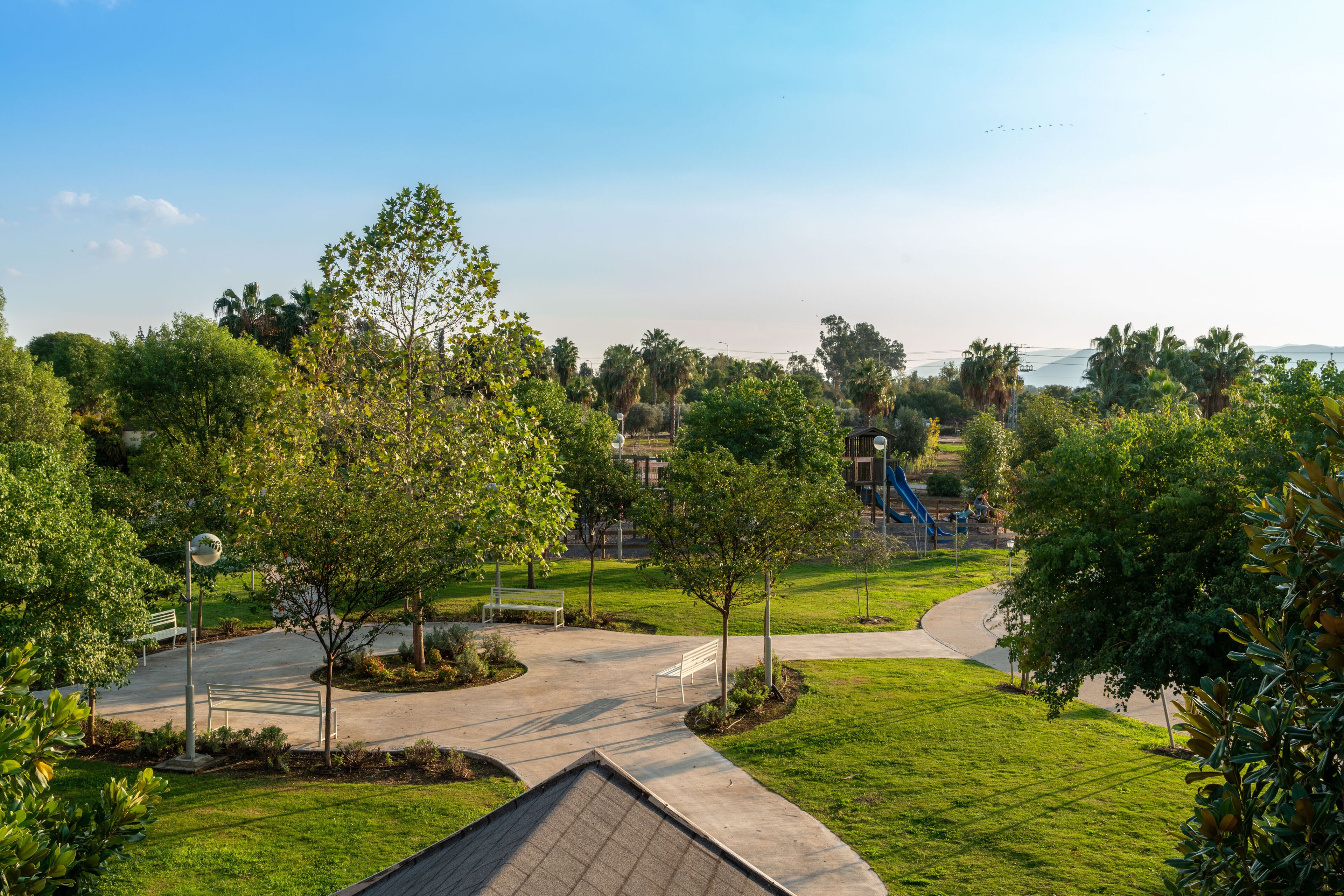 A park with pathways, benches, and trees.