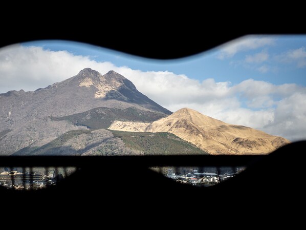A mountain landscape with a view of a town below.
