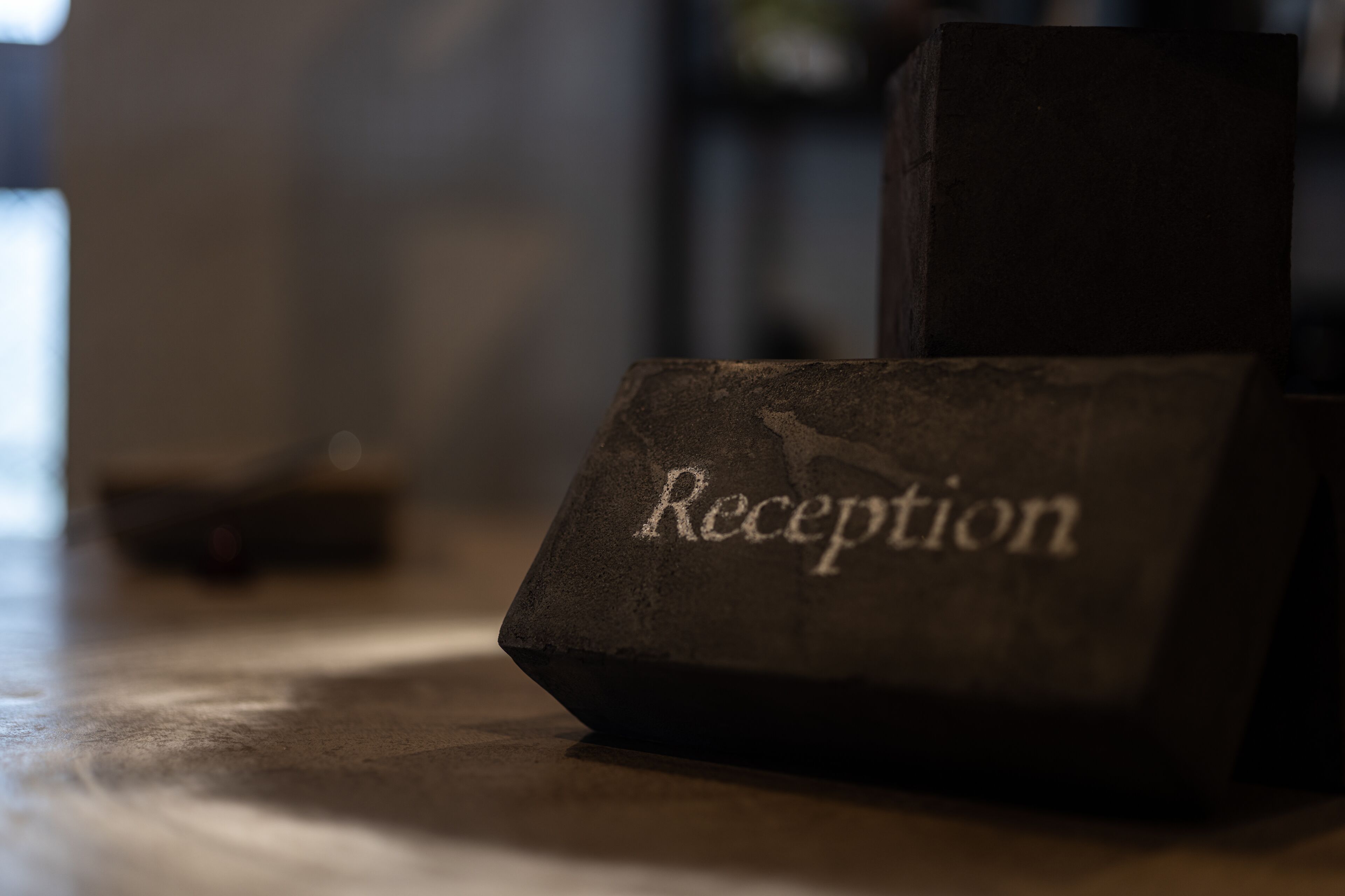 Un mostrador de recepción con la palabra 'Reception' grabada.